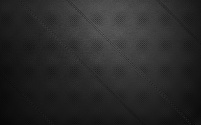 Black textured surface with diagonal lines