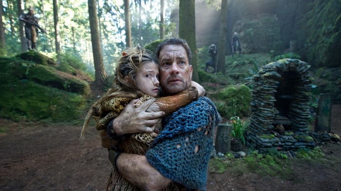 Man holding a girl in a forest with aliens