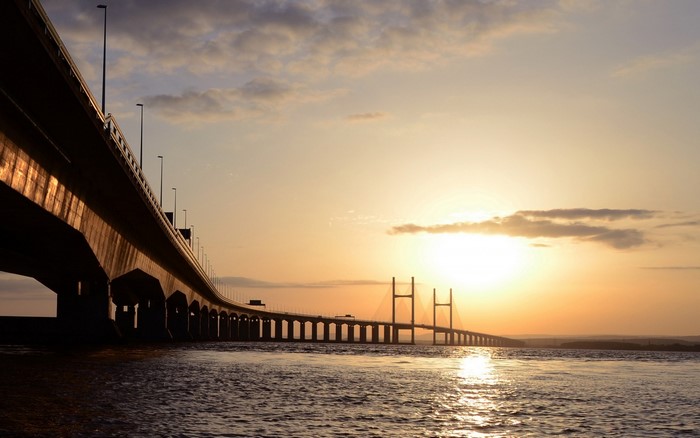 Bridge over water at sunset