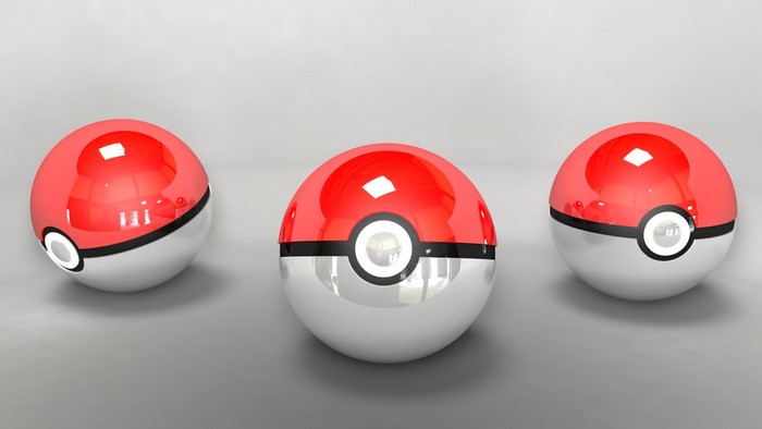 Three Pokemon balls on a gray surface