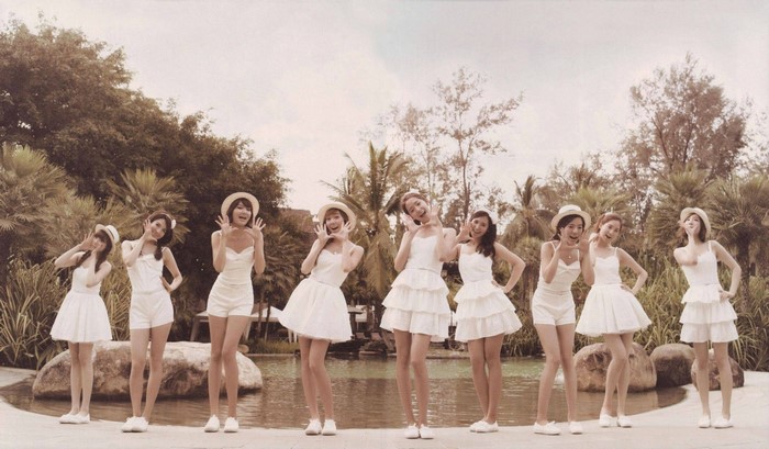Girls Generation members in white dresses outdoors