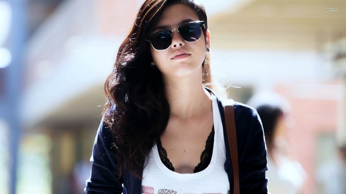 Woman wearing sunglasses and a black lace bra