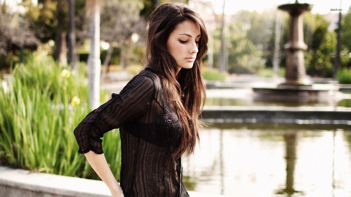 Woman with long brown hair in a black shirt
