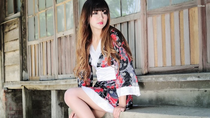 Woman in a floral kimono sitting on steps