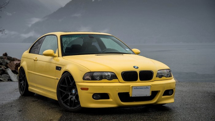 Yellow BMW M3 Coupe by a Lake