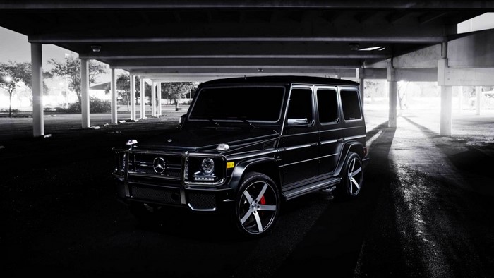 Black Mercedes-Benz G-Class parked under a structure