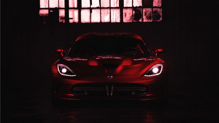 Red Dodge Viper parked in a dark garage