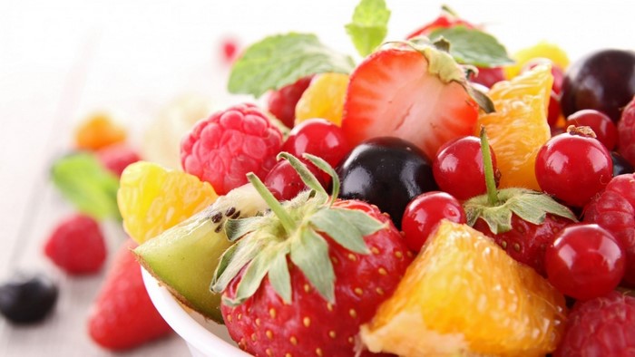 Close-up of a fruit salad with strawberries, raspberries, and oranges