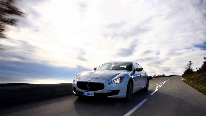 Maserati Quattroporte driving on a scenic road