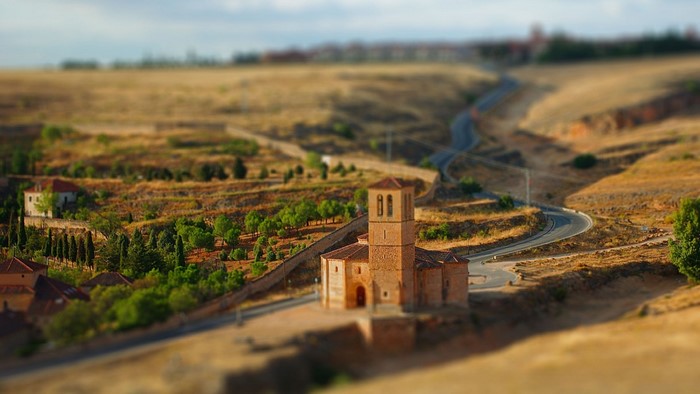 Rural landscape with church and winding road in Segovia, Spain