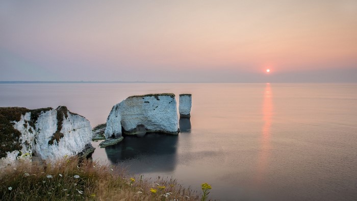 Sunset over the sea with Old Harry Rocks