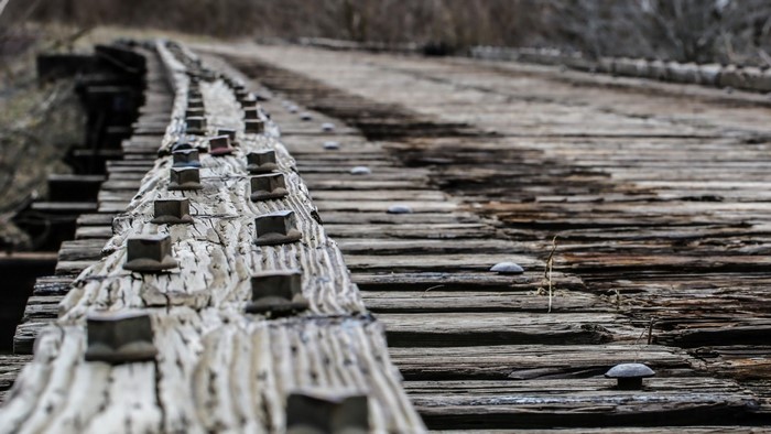 Old wooden bridge with rusted bolts