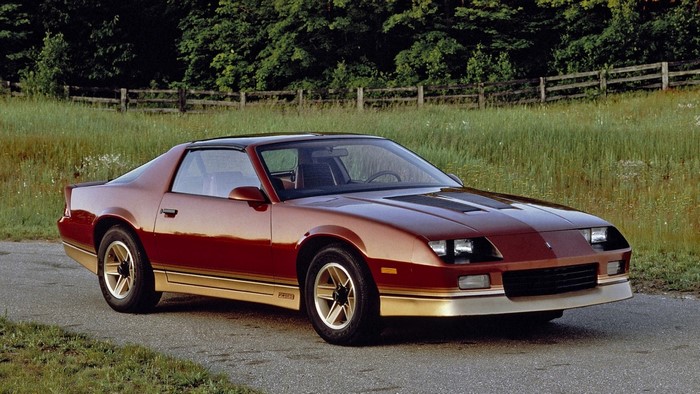 Red Chevrolet Camaro Z28 parked on a road