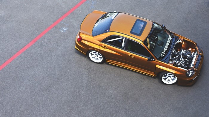 Custom orange Subaru Impreza WRX STI with open hood