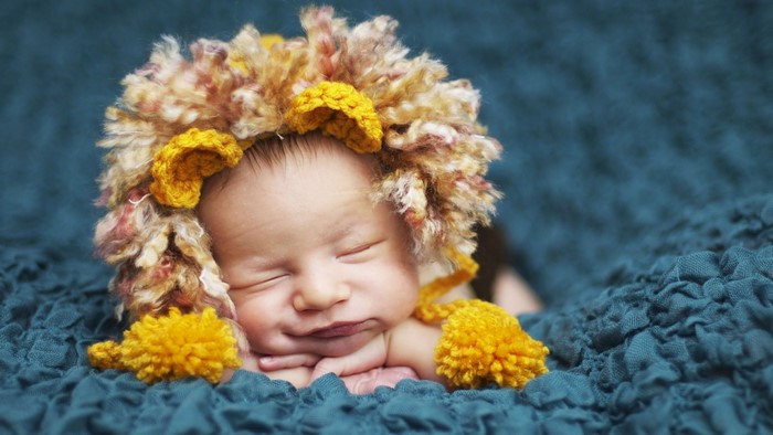Baby wearing a lion costume hat