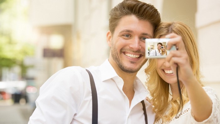 Couple taking a selfie with a camera