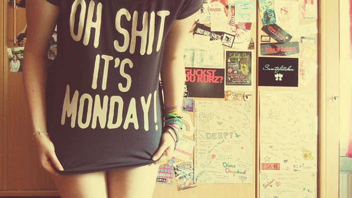 Woman wearing "Oh Shit It's Monday" T-shirt with stickers on locker