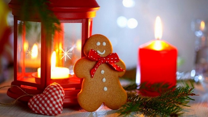 Gingerbread man with red lantern and candle