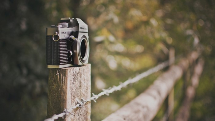 Practica MTL3 camera on a wooden post with barbed wire