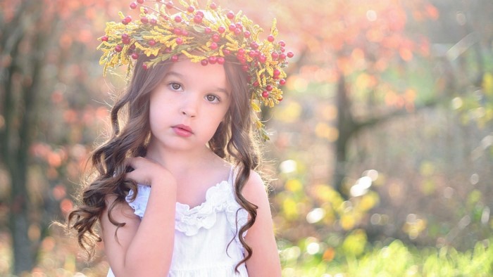 Young girl with flower crown in autumn setting