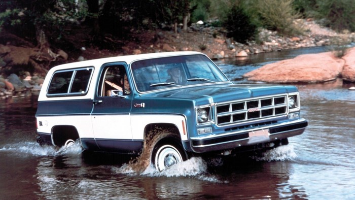 GMC Jimmy driving through a shallow river