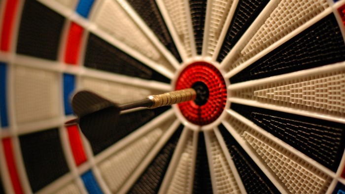Dartboard with a dart in the bullseye
