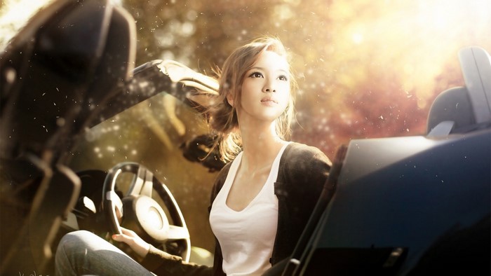 Asian woman in a car with sunlight
