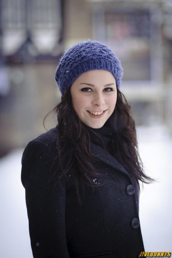 Lena Meyer Landrut wearing a blue knit hat and black coat
