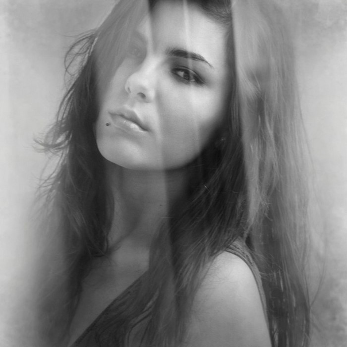 Monochrome portrait of a woman with long brown hair