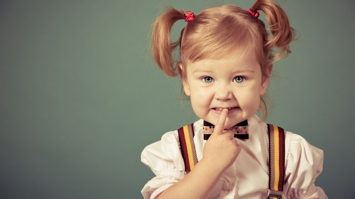 Adorable Toddler Girl with Pigtails Smiling Playfully