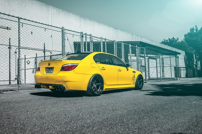 Yellow BMW M5 Sedan with custom wheels