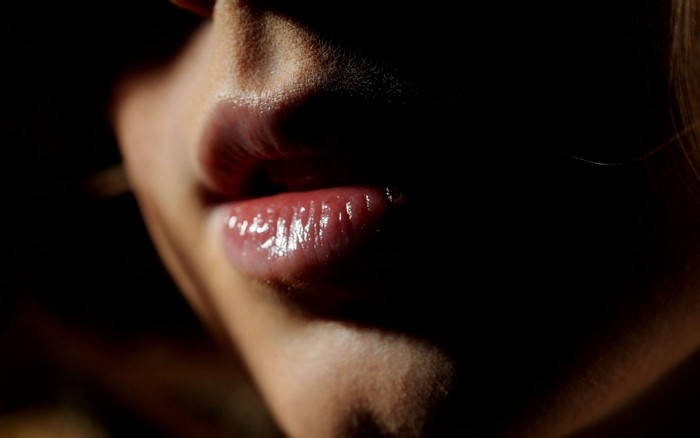 Close up of a woman's lips in darkness