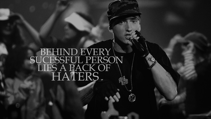 Eminem performing on stage with a crowd