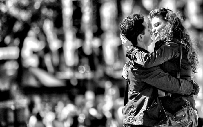 Couple embracing and kissing in black and white