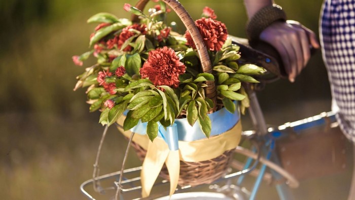 Basket of red flowers on a bicycle