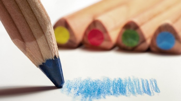 Blue pencil drawing on white paper with other colored pencils