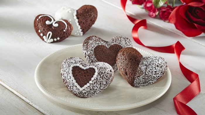 Heart-shaped chocolate cookies with icing and powdered sugar
