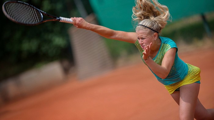 Woman playing tennis on a clay court