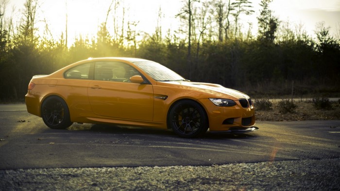 Orange BMW M3 Coupe on a Road