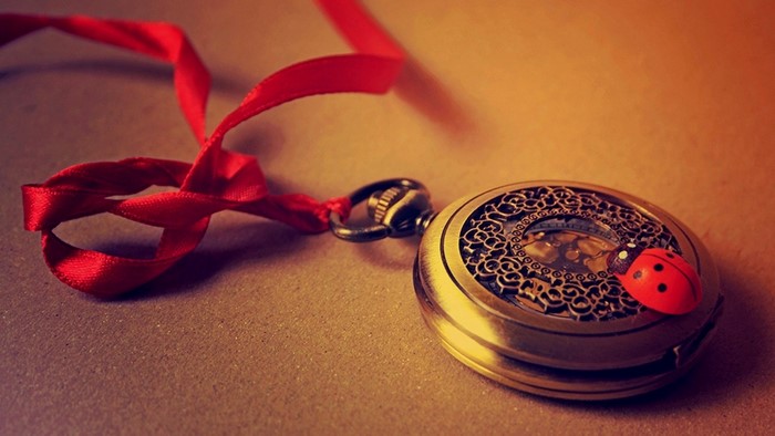 Pocket watch with red ribbon and ladybug charm