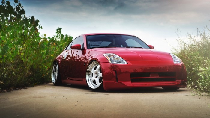 Red Nissan 350Z sports car on a dirt road