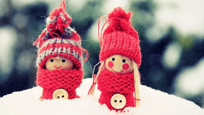 Two knitted Christmas dolls in the snow