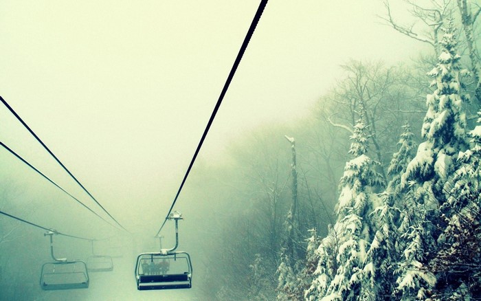 Ski lift in a foggy winter forest
