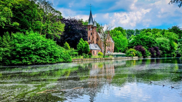 Castle reflection on a lake surrounded by trees