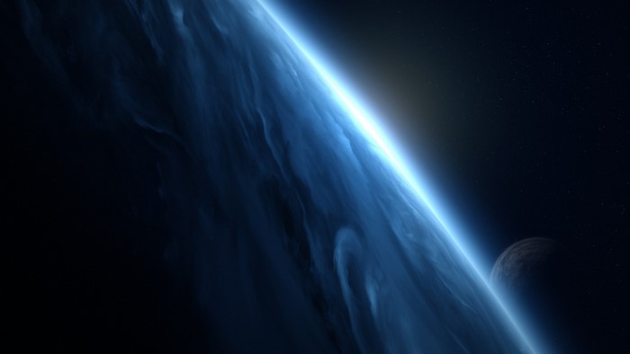 Planet and moon in space with bright light