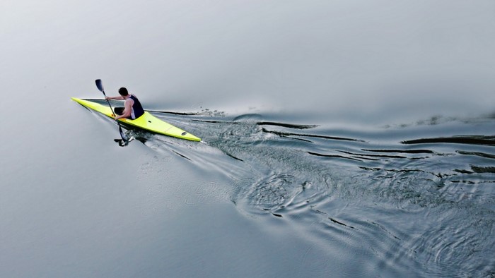Man kayaking on a calm lake