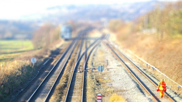 Person in high-visibility clothing on train tracks