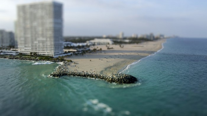 Beach with high-rise building and breakwater