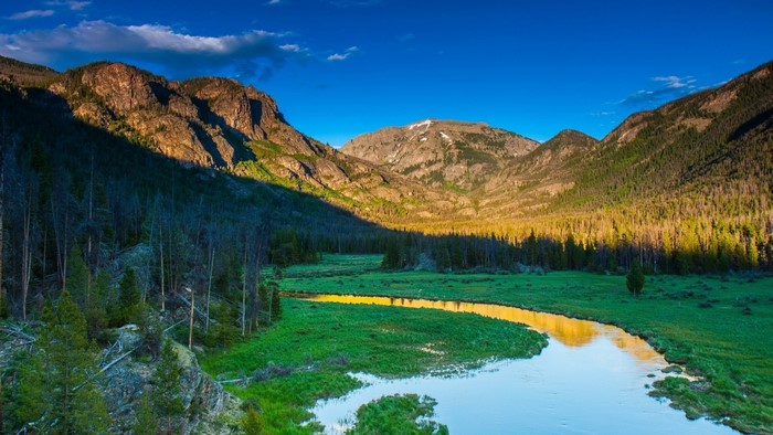 River flowing through a mountain valley at sunset