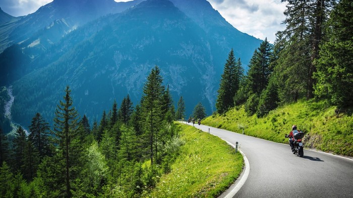 Motorcyclists on a mountain road in the Alps